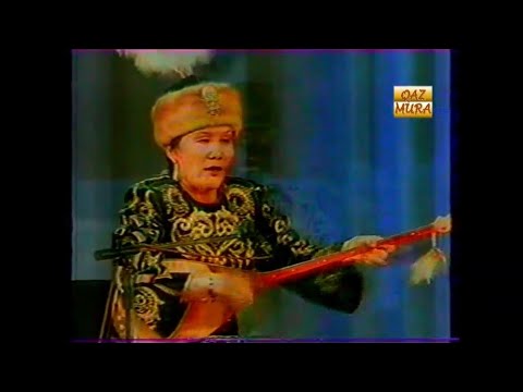 Видео: Мұхамеджан Тазабеков пен Әсия Беркенованың айтысы | Халық ақыны Әсия Беркенова 75 жаста