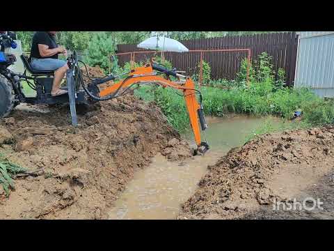 Видео: Копаем пруд минитрактором.