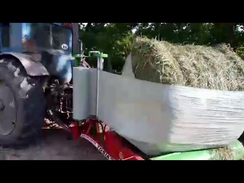 Видео: Крутим Сенаж Плёнкой | Обзор обмотчик рулонов