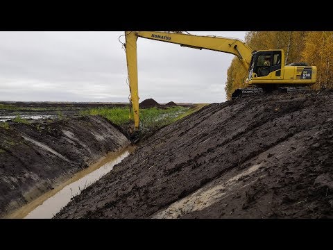 Видео: Чистим валовую канаву длинноруким экскаватором