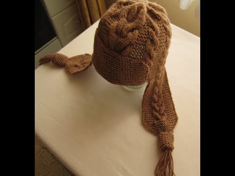 Видео: ВЯЗАНИЕ СПИЦАМИ ШАПКА С УШКАМИ С УЗОРАМИ КОСЫ! Видео урок.  knitting.