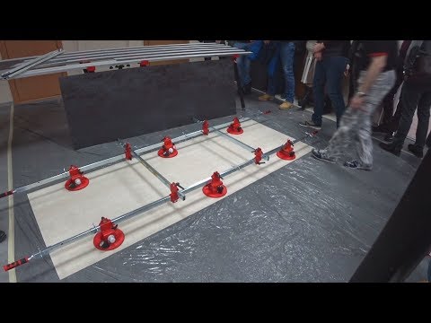Видео: Работа с крупноформатной плиткой. Оборудование. Бесшовная укладка. Клей.