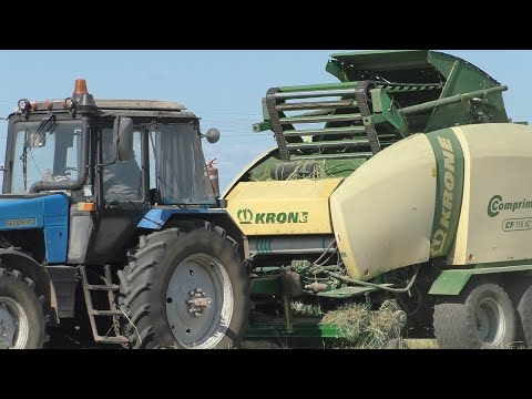 Видео: прессование сена в рулоне, мтз 1221, krone comprima cf 155 xc