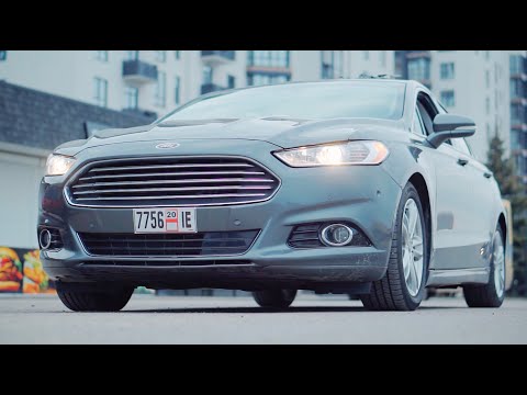 Видео: Обзор Ford Fusion Hybrid. 5 литров расход и надежность. Что еще нужно? Авто из США.