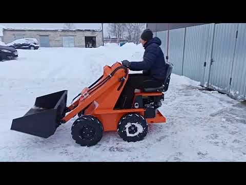 Видео: Бортоповоротный универсальный мини-погрузчик. Работа на уборке снега.