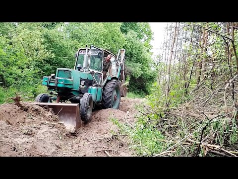 Видео: ЮМЗ эо2621 пробить дорогу через лес.