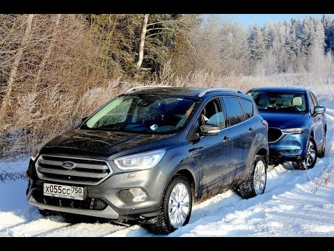 Видео: Форд Куга - Мазда СХ 5: тест по сугробам, да еще потом в дрифте