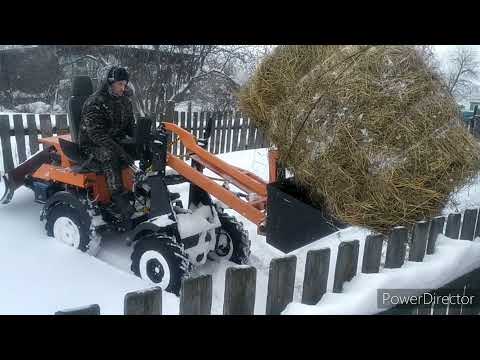 Видео: Поворотный отвал на заднюю навеску мини-погрузчика